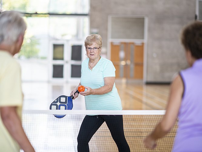 Older adults playing pickleball at Diane Hamre Recreation Complex.
