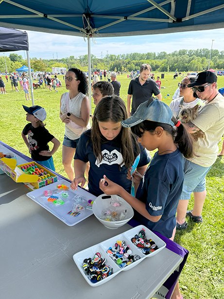 Onsite activities at the Newcastle Community Park grand opening included friendship bracelet stations (pictured), as well as face painting, jumping castles, an obstacle course, pickleball lessons and free swimming. 