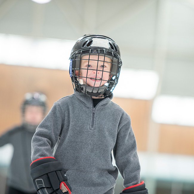 Boy wearing an CSA-approved helmet skating at Garnet B. Rickard Recreation Complex.