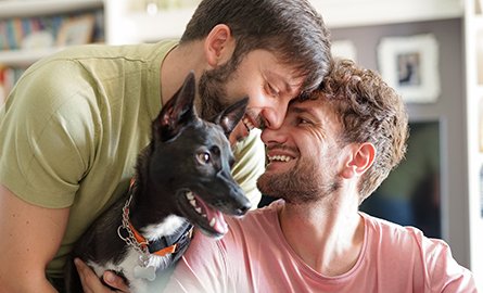 A couple at home with their adopted dog