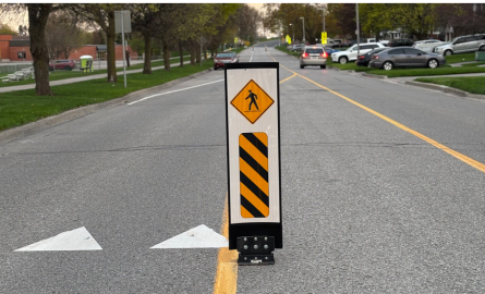 Roadway with flexible signs bolted